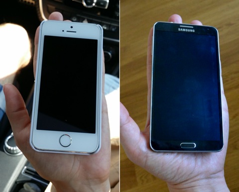 A person with small hands holding an iPhone 5, and a person with large hands holding a Galaxy Note 3; relative to the hands, both phones look similarly sized