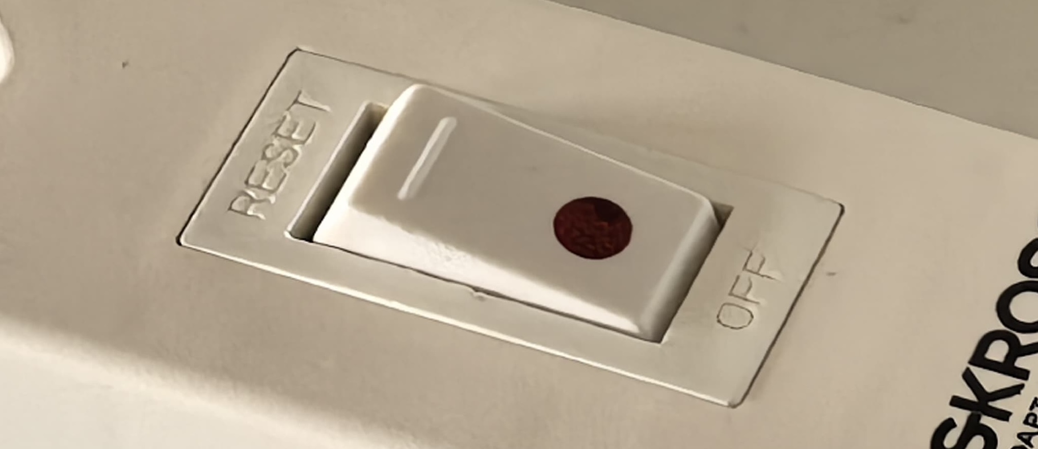 Toggle on a power strip with "Reset" and "Off" labels